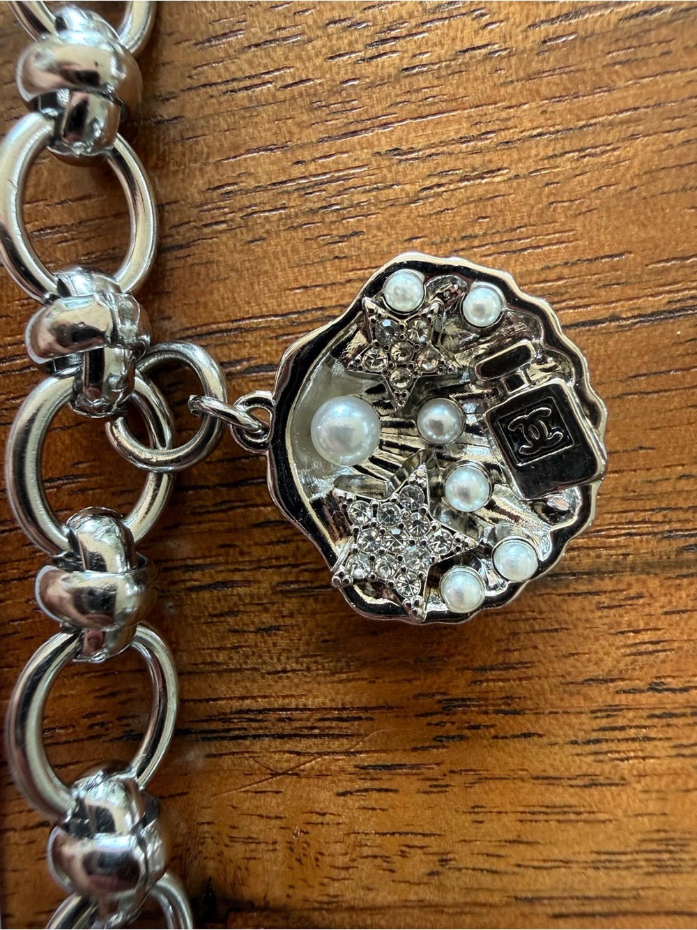Silver-Tone Charm Link Bracelet with Silver Clam Shell of Embellishments.